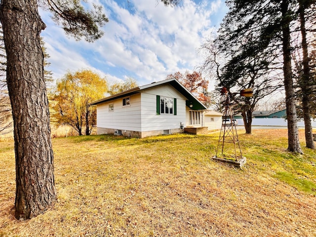 view of property exterior featuring a lawn