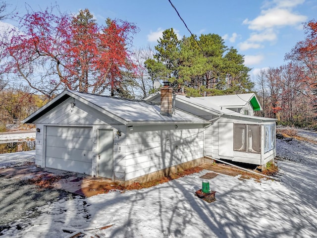 view of side of home featuring a garage