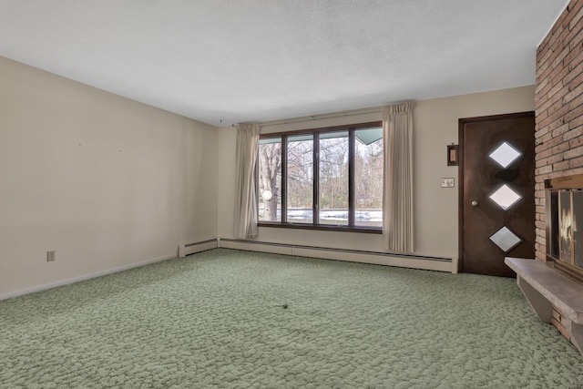 foyer with carpet floors, a textured ceiling, a baseboard radiator, and a brick fireplace