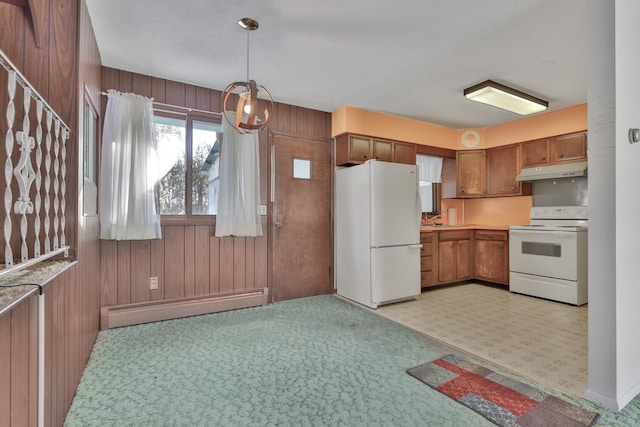 kitchen with a baseboard heating unit, decorative light fixtures, white appliances, and wood walls