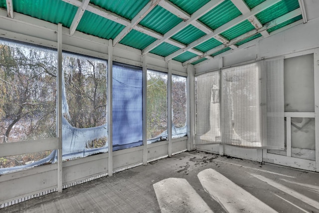 unfurnished sunroom featuring vaulted ceiling