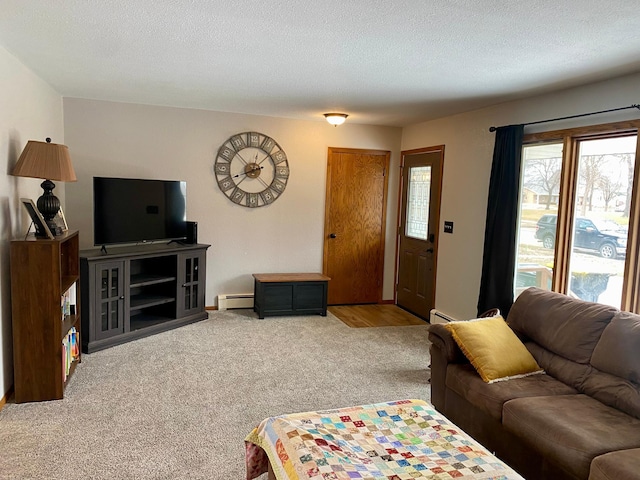 living room with a baseboard radiator, carpet, and a textured ceiling