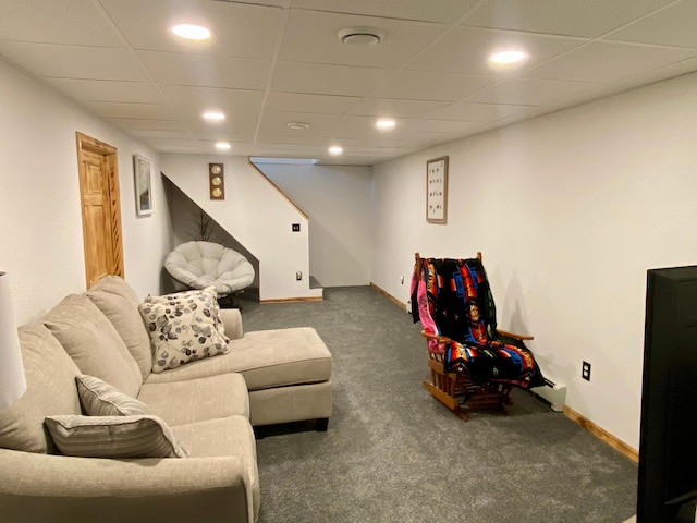 carpeted living room featuring a paneled ceiling