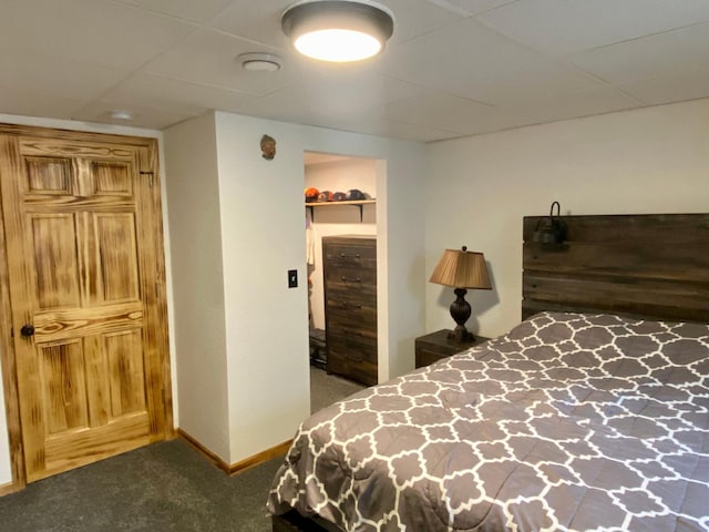 carpeted bedroom featuring a walk in closet