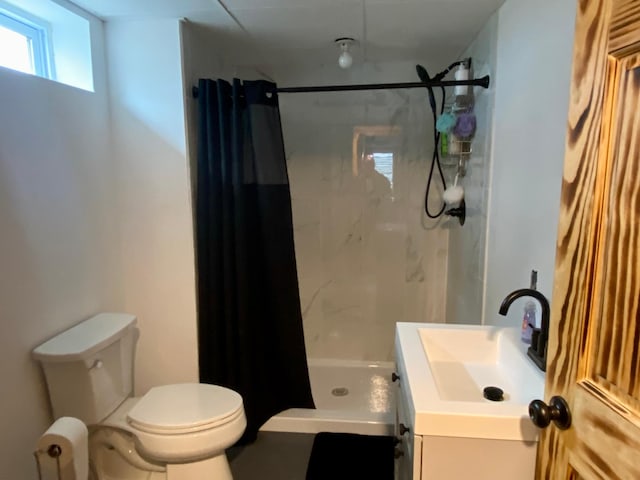 bathroom with vanity, toilet, and walk in shower