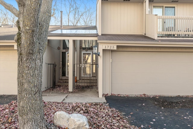 doorway to property featuring a balcony and a garage