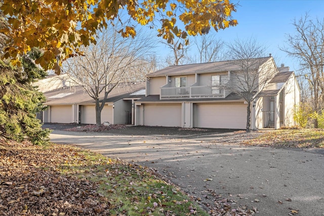 view of property featuring a balcony and a garage