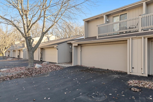 view of property featuring a balcony and a garage