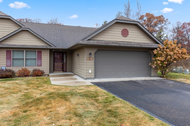 ranch-style home with a front lawn and a garage