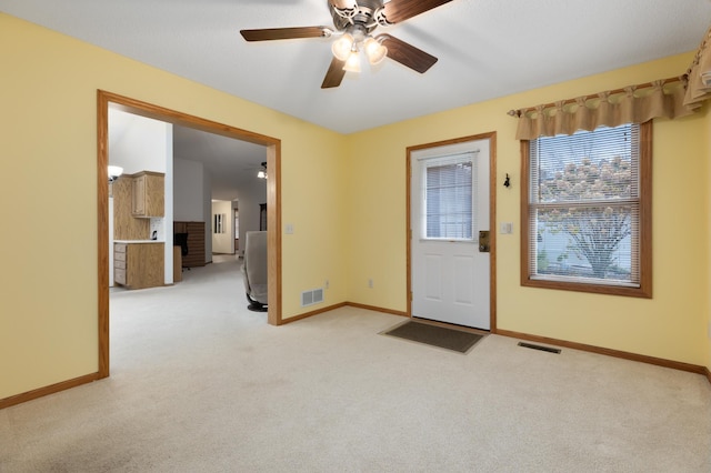 foyer with light colored carpet and ceiling fan