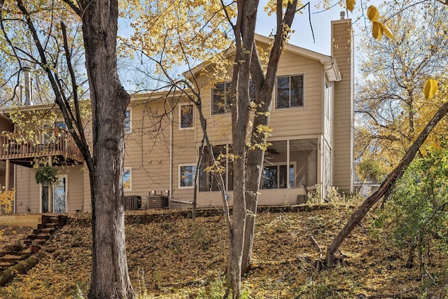 rear view of house featuring central air condition unit