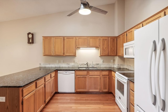 kitchen with light hardwood / wood-style flooring, kitchen peninsula, sink, white appliances, and ceiling fan