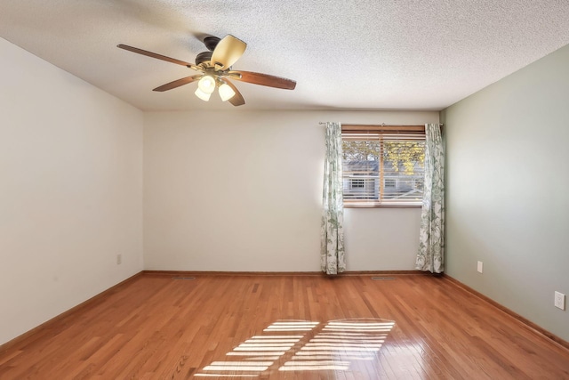 empty room featuring ceiling fan, a textured ceiling, and light hardwood / wood-style flooring