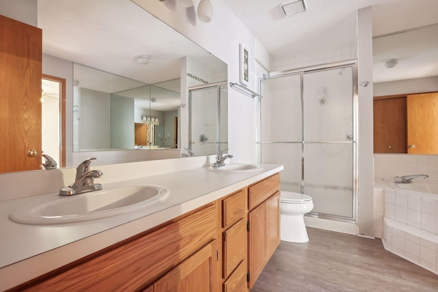 full bathroom with vanity, shower with separate bathtub, wood-type flooring, and toilet