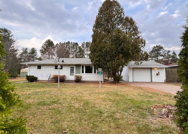 view of front of house with a front yard and a garage