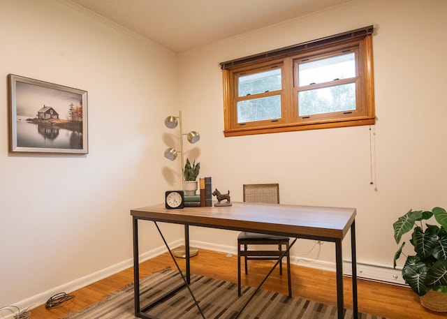 home office featuring hardwood / wood-style floors and crown molding