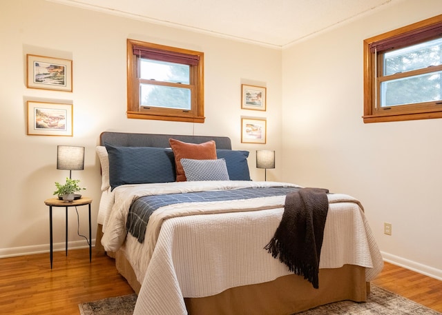 bedroom featuring hardwood / wood-style floors and ornamental molding