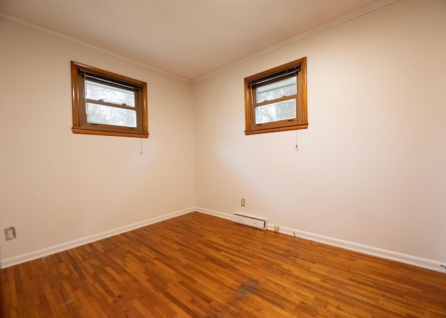 empty room with wood-type flooring and ornamental molding