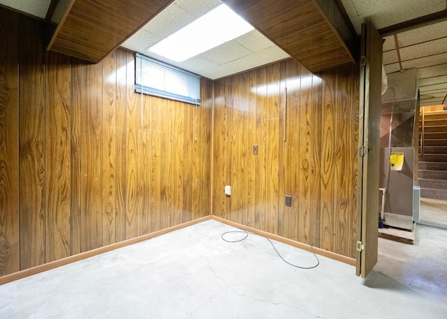 basement featuring wooden walls