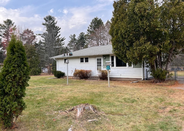 rear view of property featuring a yard