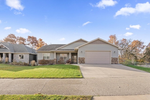 view of front of property with a garage and a front lawn