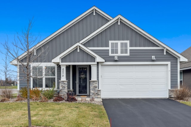 craftsman-style home with a front lawn and a garage