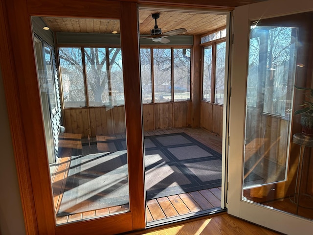 unfurnished sunroom featuring ceiling fan and wood ceiling