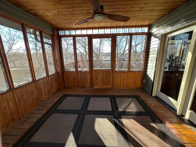 unfurnished sunroom featuring ceiling fan and wooden ceiling