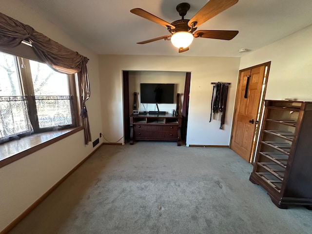 unfurnished bedroom with ceiling fan and light carpet