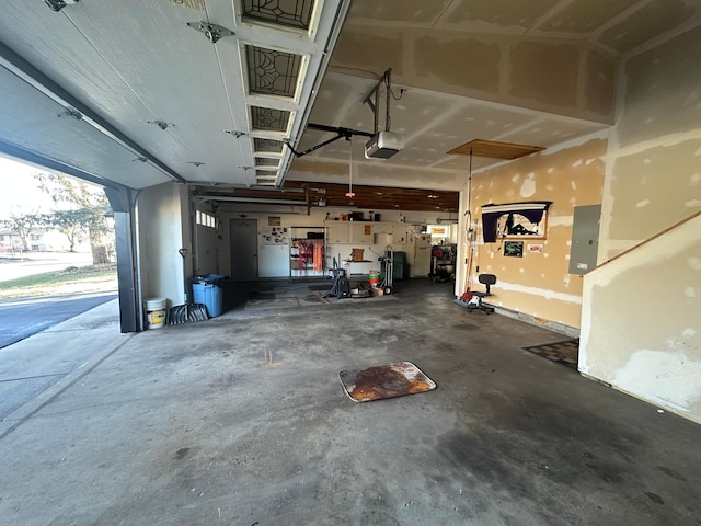 garage featuring electric panel and a garage door opener