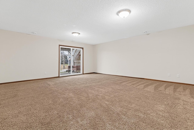 carpeted empty room with a textured ceiling