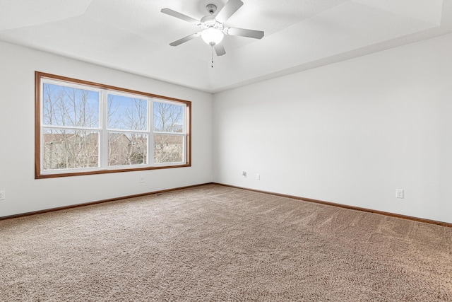 carpeted spare room with ceiling fan