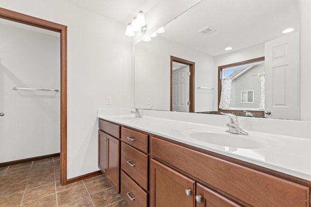 bathroom featuring tile patterned flooring and vanity