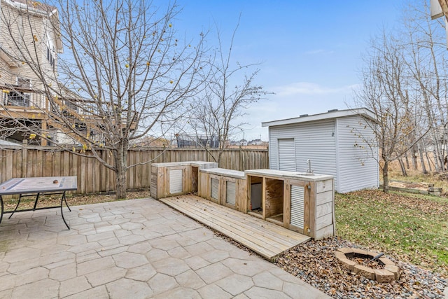 view of patio with an outdoor fire pit and a wooden deck