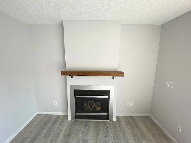 room details featuring wood-type flooring and a textured ceiling