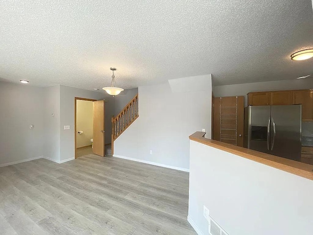 interior space featuring light hardwood / wood-style flooring and a textured ceiling