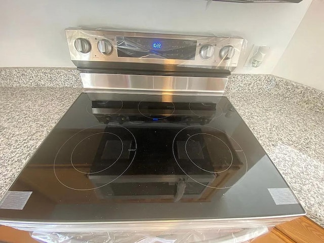 room details featuring stainless steel range with electric cooktop