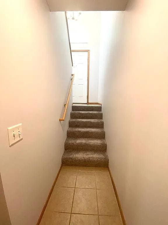 staircase with tile patterned floors