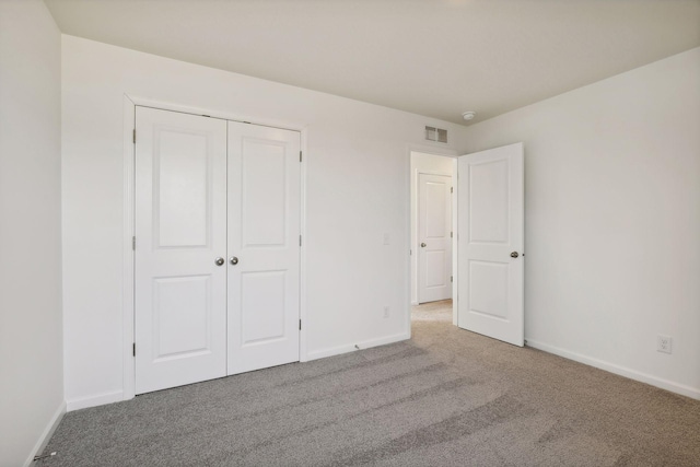 unfurnished bedroom featuring carpet and a closet