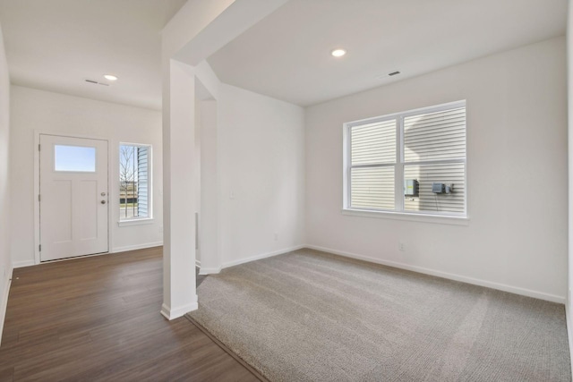 entryway featuring plenty of natural light and dark hardwood / wood-style floors