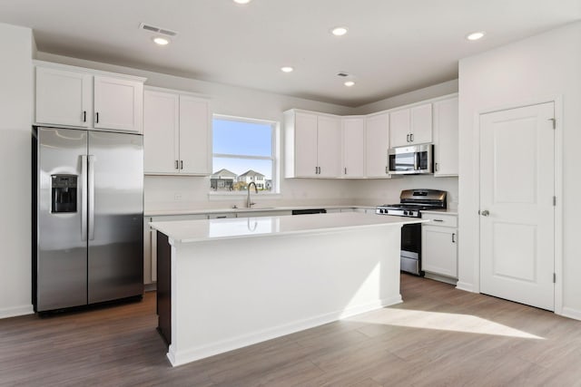 kitchen with a center island, white cabinets, and appliances with stainless steel finishes