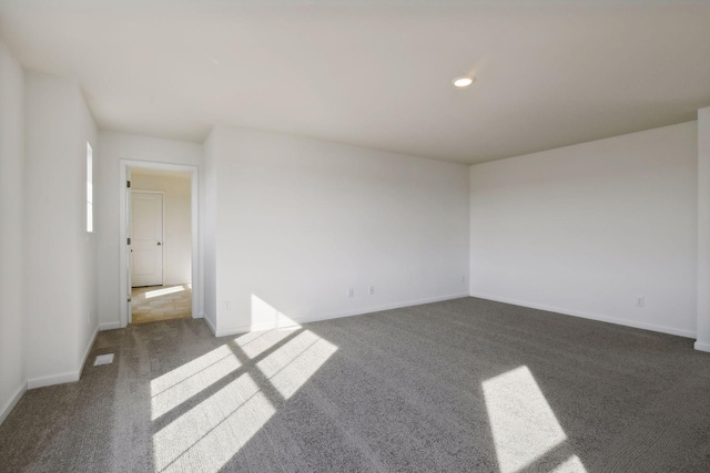 empty room with dark colored carpet