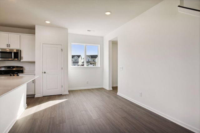 kitchen featuring hardwood / wood-style flooring, white cabinets, and appliances with stainless steel finishes