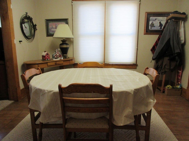 dining area featuring dark wood-type flooring