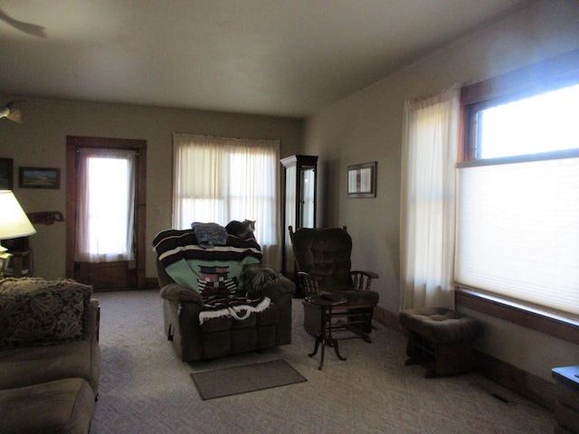 living room with light carpet and a healthy amount of sunlight