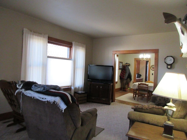 living room featuring a notable chandelier and carpet