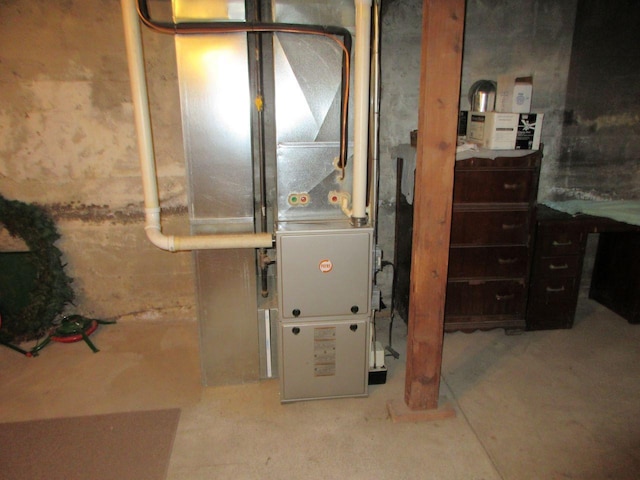 utility room featuring heating unit