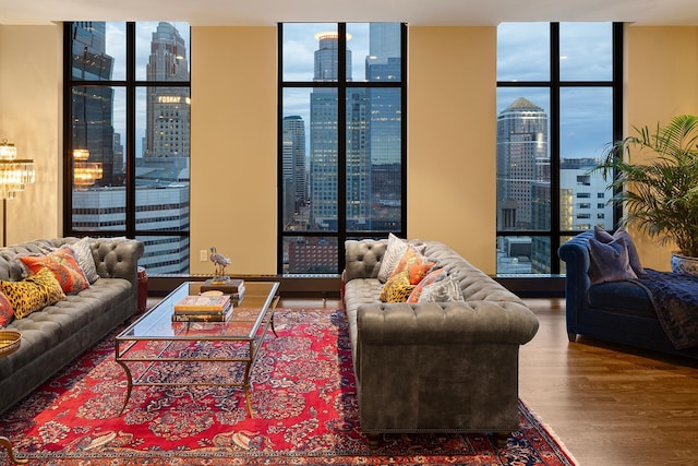 living room with hardwood / wood-style floors, a wealth of natural light, and a wall of windows