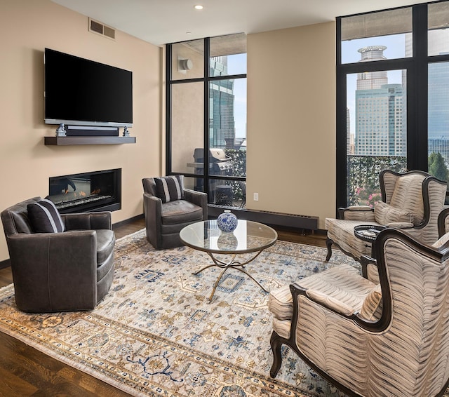 living room featuring plenty of natural light, hardwood / wood-style flooring, and floor to ceiling windows