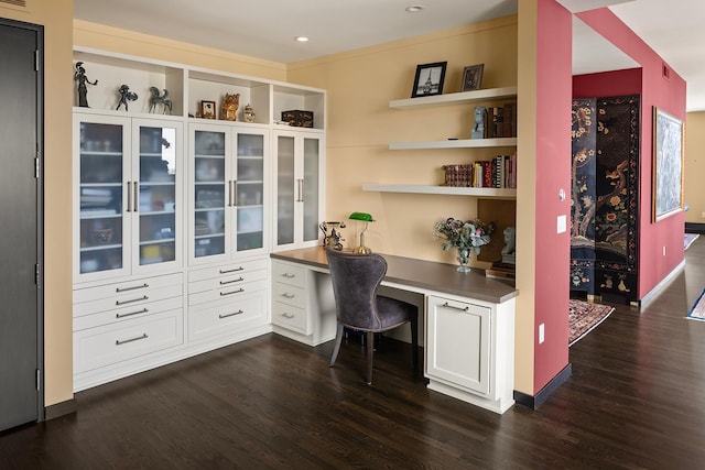 office featuring dark hardwood / wood-style flooring and built in desk